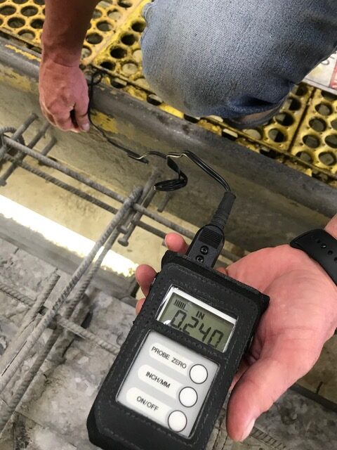 A Construction Worker Holding a Probe Thermometer